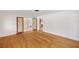 Spacious living room with hardwood floors and open access to a bonus room at 936 Alcazar Way S, St Petersburg, FL 33705