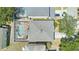 Aerial view of the home's roof and the screened-in pool in the fenced backyard at 10505 Boyette Creek Blvd, Riverview, FL 33569