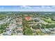 Aerial view of a neighborhood with houses and mature trees near a pond with a house marked with a pin at 10505 Boyette Creek Blvd, Riverview, FL 33569
