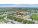 Aerial view of a neighborhood with lush trees and a home marked with a pin near a pond at 10505 Boyette Creek Blvd, Riverview, FL 33569