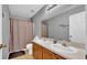 Bathroom with double sink vanity, large mirror, and shower, offering convenience and functionality for everyday use at 10505 Boyette Creek Blvd, Riverview, FL 33569