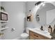 Cozy bathroom with modern fixtures including a vessel sink, framed mirror and humorous decor at 10505 Boyette Creek Blvd, Riverview, FL 33569