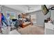 Functional bedroom with a wooden bunk bed, ceiling fan, and neutral walls, offering a versatile living space at 10505 Boyette Creek Blvd, Riverview, FL 33569