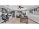 Finished bonus room with sports-themed decor, fan, casual seating, and comfortable carpeted floor at 10505 Boyette Creek Blvd, Riverview, FL 33569