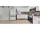 Spacious kitchen features stainless steel appliances, white cabinetry, and a tile backsplash at 10505 Boyette Creek Blvd, Riverview, FL 33569