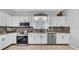 Clean white kitchen with stainless steel appliances and modern backsplash at 10505 Boyette Creek Blvd, Riverview, FL 33569