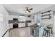 Well-lit kitchen features stainless steel appliances, light cabinets, and a breakfast bar with seating at 10505 Boyette Creek Blvd, Riverview, FL 33569