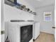 Efficient laundry room equipped with a washer, dryer, and shelving for storage, enhancing convenience and organization at 10505 Boyette Creek Blvd, Riverview, FL 33569