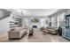 Open living room showcasing wood floors, modern decor, and lots of natural light at 10505 Boyette Creek Blvd, Riverview, FL 33569