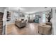 Open living room with wood floors, modern decor, and lots of natural light at 10505 Boyette Creek Blvd, Riverview, FL 33569
