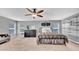 Comfortable main bedroom with a ceiling fan, neutral carpet, multiple windows, and closet at 10505 Boyette Creek Blvd, Riverview, FL 33569