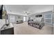 Expansive bedroom featuring a large bed, seating area, and abundant natural light from multiple windows at 10505 Boyette Creek Blvd, Riverview, FL 33569
