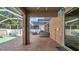 Relaxing outdoor patio with brick flooring, screened enclosure, and a view of the pool, ideal for leisure and entertainment at 10505 Boyette Creek Blvd, Riverview, FL 33569