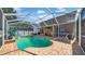Covered pool area with brick deck, fenced in yard, and outdoor seating at 10505 Boyette Creek Blvd, Riverview, FL 33569