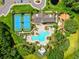 Aerial view of the community amenities including a pool, tennis courts, playground and clubhouse offers a fun lifestyle at 10901 Sundrift Dr, Tampa, FL 33647