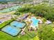 Aerial view of the community pool, tennis courts, and lush landscaping is an inviting oasis for families at 10901 Sundrift Dr, Tampa, FL 33647