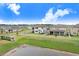 Aerial view of the community featuring fenced backyards, manicured lawns, and a tranquil pond in the distance at 10901 Sundrift Dr, Tampa, FL 33647