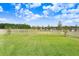 Large green backyard enclosed by a white fence at 10901 Sundrift Dr, Tampa, FL 33647