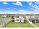 Backyard featuring a well-maintained lawn, white vinyl fencing, and a covered patio ideal for outdoor relaxation at 10901 Sundrift Dr, Tampa, FL 33647