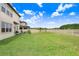 Spacious backyard with green grass and a white fence with lake views at 10901 Sundrift Dr, Tampa, FL 33647