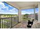 Relaxing balcony with chairs overlooks the lake and green landscape at 10901 Sundrift Dr, Tampa, FL 33647