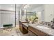 Elegant bathroom featuring granite countertops, dual sinks, and a glass-enclosed shower at 10901 Sundrift Dr, Tampa, FL 33647