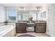 A bright bathroom offers a double vanity, a soaking tub and a separate glass shower at 10901 Sundrift Dr, Tampa, FL 33647
