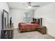 Cozy bedroom with a bed, rustic furniture and a large window for plenty of natural light at 10901 Sundrift Dr, Tampa, FL 33647