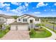 Charming two-story home boasts a three-car garage, beautiful landscaping, and serene neighborhood views in a sunny locale at 10901 Sundrift Dr, Tampa, FL 33647