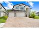 Beautiful two-story home featuring a stone facade and a three-car garage at 10901 Sundrift Dr, Tampa, FL 33647