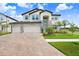 Gorgeous home boasts a brick-paved driveway and a manicured lawn at 10901 Sundrift Dr, Tampa, FL 33647