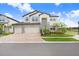 Beautiful two-story home featuring a stone facade and a three-car garage, complemented by lush landscaping at 10901 Sundrift Dr, Tampa, FL 33647