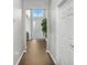 Hallway with hardwood flooring and a high ceiling showing the entryway at 10901 Sundrift Dr, Tampa, FL 33647