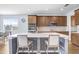The kitchen island features barstool seating, a sink, and stone countertops at 10901 Sundrift Dr, Tampa, FL 33647
