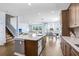 Spacious kitchen with stainless steel appliances, stone countertops, and bar stool seating at 10901 Sundrift Dr, Tampa, FL 33647