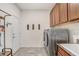 Convenient laundry room with washer, dryer, cabinets, and tiled floor at 10901 Sundrift Dr, Tampa, FL 33647