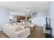 Spacious living room with modern furniture, fan and open floor plan flowing into the kitchen at 10901 Sundrift Dr, Tampa, FL 33647