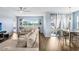 Bright, open-concept living space with hardwood floors and comfortable, oversized furniture at 10901 Sundrift Dr, Tampa, FL 33647