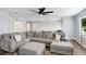 Living room offers a comfortable sectional sofa, media center, and bright natural lighting at 10901 Sundrift Dr, Tampa, FL 33647
