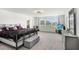 Spacious main bedroom features a cozy sitting area, large windows and en suite bathroom access at 10901 Sundrift Dr, Tampa, FL 33647