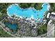 Overhead view of a crystal-clear lagoon in a Primary-planned community with a parking lot and recreation areas at 11079 Linden Depot Rd, San Antonio, FL 33576