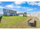 Spacious backyard featuring a playground, a garden bed, and a white vinyl fence at 11079 Linden Depot Rd, San Antonio, FL 33576