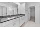 Modern bathroom with granite countertop, dual sinks, and subway tile shower at 11079 Linden Depot Rd, San Antonio, FL 33576