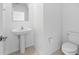Well-lit half-bathroom with a pedestal sink and tile flooring at 11079 Linden Depot Rd, San Antonio, FL 33576
