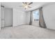 Cozy bedroom with closet, carpet, ceiling fan, and natural lighting at 11079 Linden Depot Rd, San Antonio, FL 33576