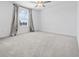 Bright bedroom features plush carpeting, a large window, and neutral color scheme at 11079 Linden Depot Rd, San Antonio, FL 33576