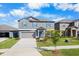 Two-story home with a well-manicured lawn, tidy flower beds, and a two-car garage at 11079 Linden Depot Rd, San Antonio, FL 33576