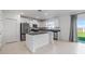 Bright kitchen featuring white cabinets, stainless steel appliances, and a granite countertop island at 11079 Linden Depot Rd, San Antonio, FL 33576