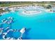 Aerial view of a pristine lagoon featuring an inflatable water park in a Primary-planned community at 11079 Linden Depot Rd, San Antonio, FL 33576