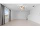 Bright living room with tile flooring, ceiling fan, and large window at 11079 Linden Depot Rd, San Antonio, FL 33576